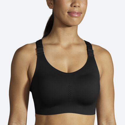 woman in gray razorback sports bra and black jogging pants