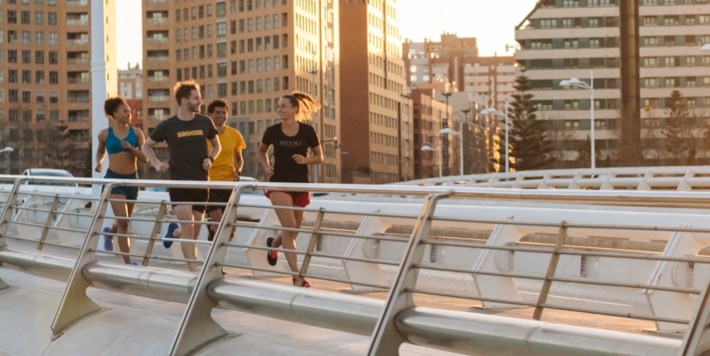 A group of runners head out for some morning miles just as the sun is rising.