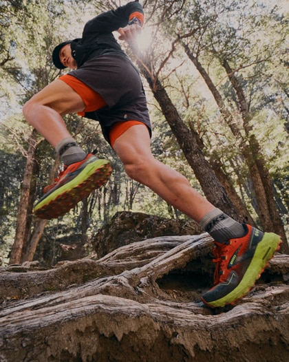 Trail runner climbing up in Cascadia running shoes
