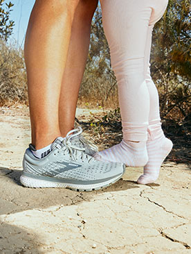 Anels child standing on her Brooks running shoes