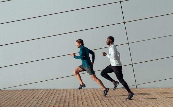 Side view of two men running