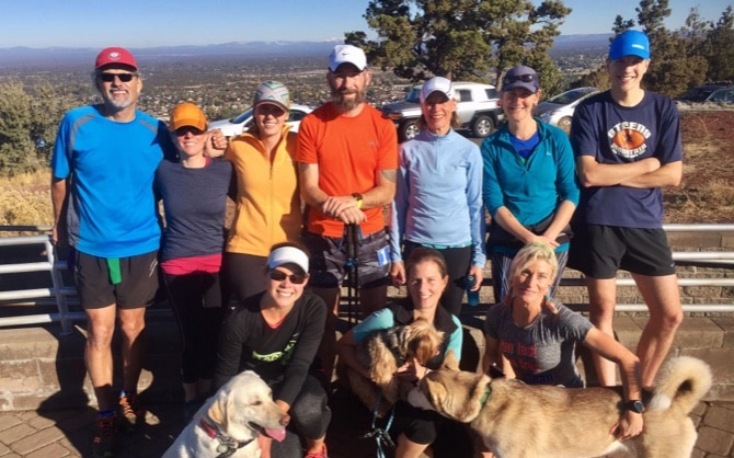 Cean is pictured standing in the middle of his support crew after finishing the Pilot Butte 100.