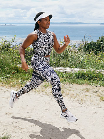 Olu running with the ocean behind her