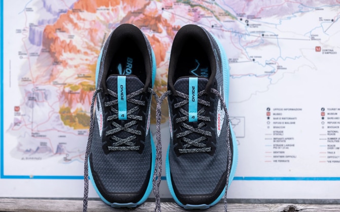 Trail running shoes in front of a trail running route map