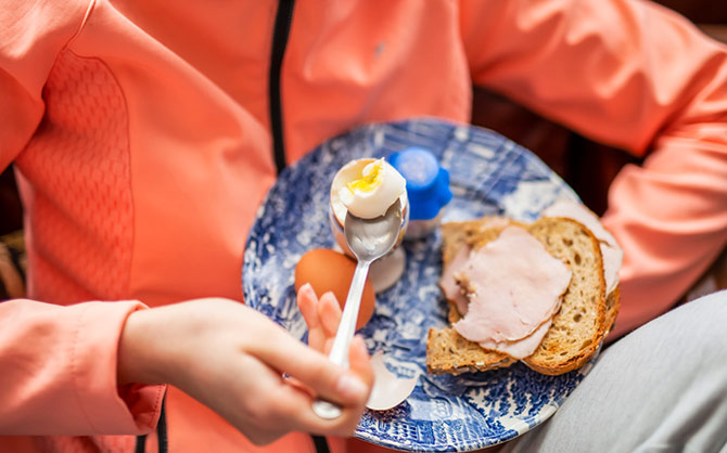 Plate with an egg and lunch meant on toast