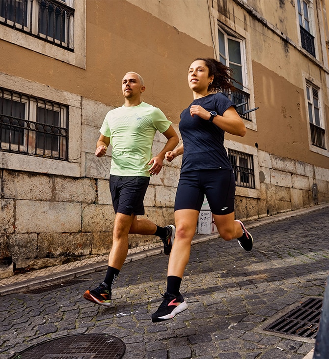 Long shot of a woman and a man wearing the new Ghost 16 running shoes from Brooks Running
