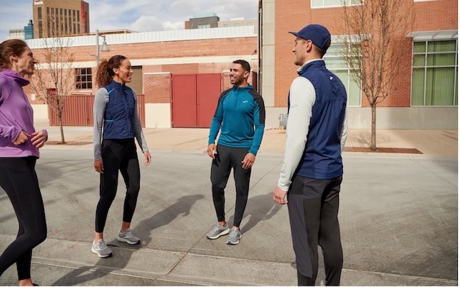 Four runners chatting outside