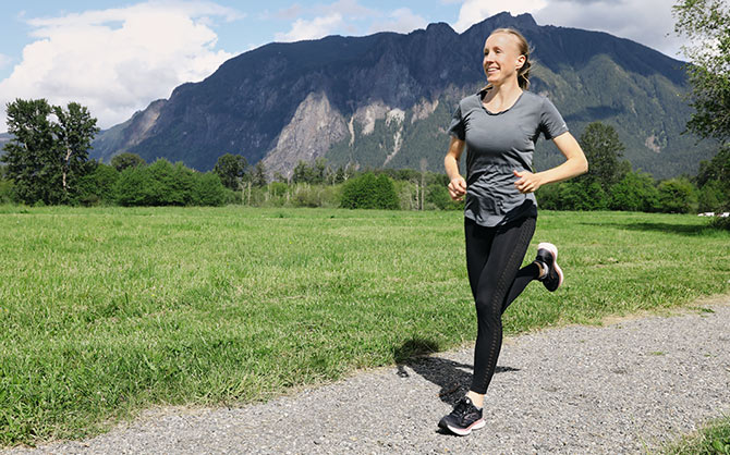 Ladia running with a mountain behind her