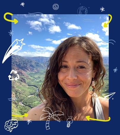 A woman on a hike, smiling at the camera