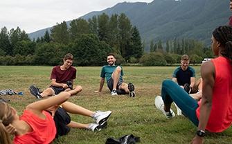 Athletes sitting in circle stretching