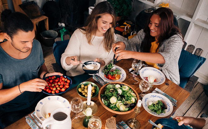 Friends sitting at a table to eat together.