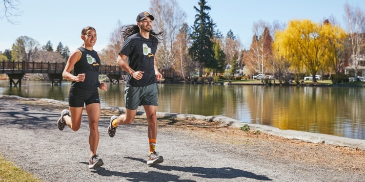 2 runners running by a river