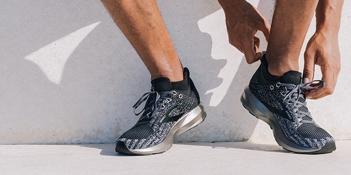 A close-up of a pair of runner’s feet wearing the Brooks Levitate 3 road-running shoes.