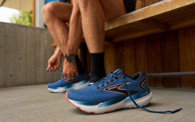 Runners are mid-stride wearing Brooks shoes with soft DNA LOFT cushioning