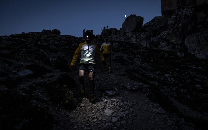 Trail runners with headlamps running in the dark