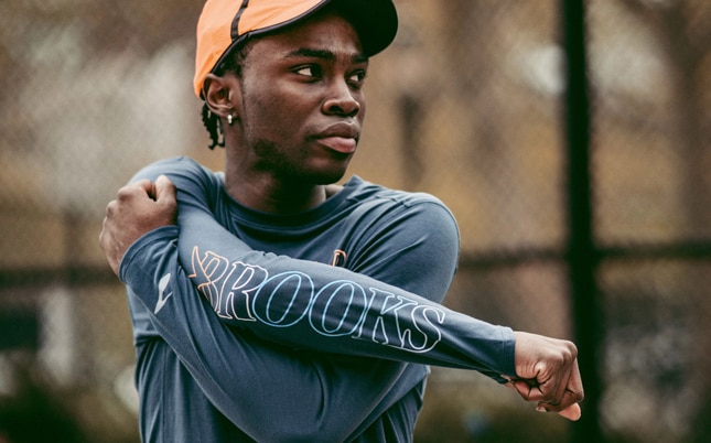 Runner stretching his right arm before his run