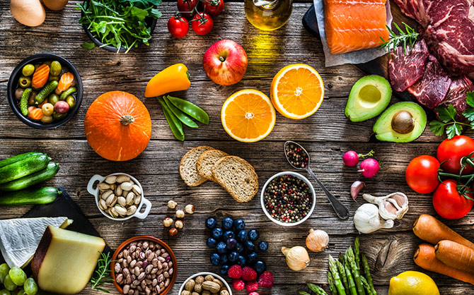 An array of fruits, vegetables, and grains spread out. 