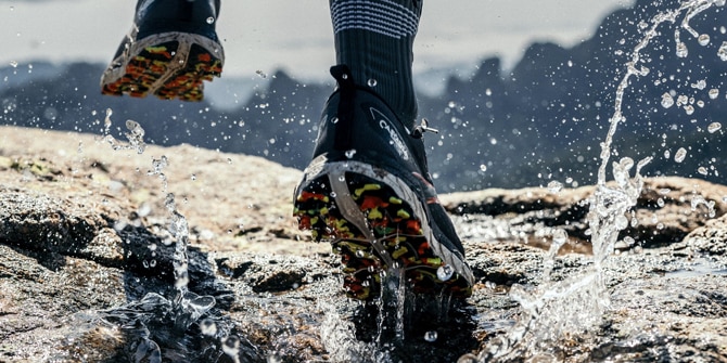 Runner running through a puddle in waterproof running shoes