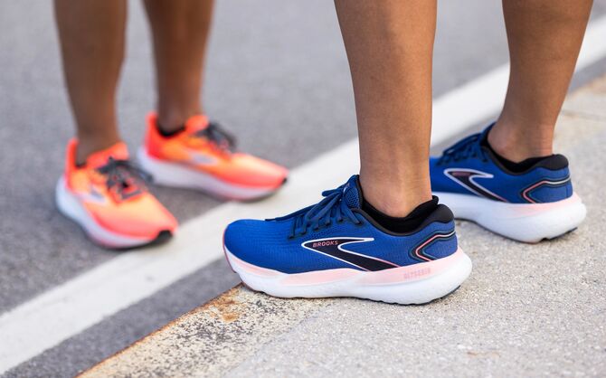 Low-angle show of two runners wearing running shoes.