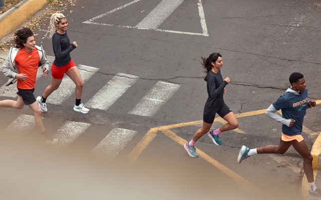 Helicopter view of runners crossing a street