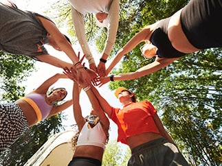 Runners putting their hands together