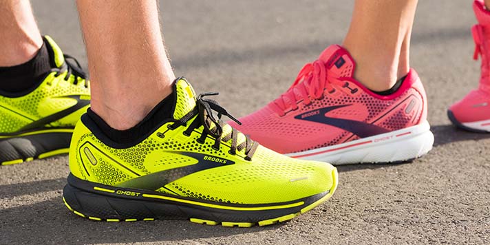 a close up of yellow and pink running shoes