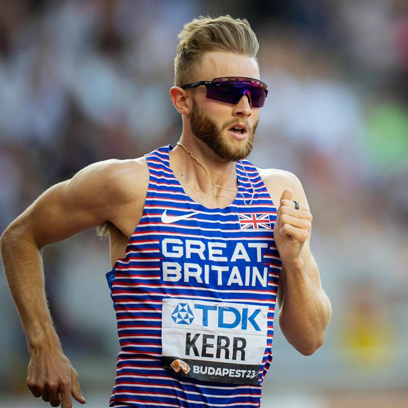 Medium shot of Josh Kerr on a running track