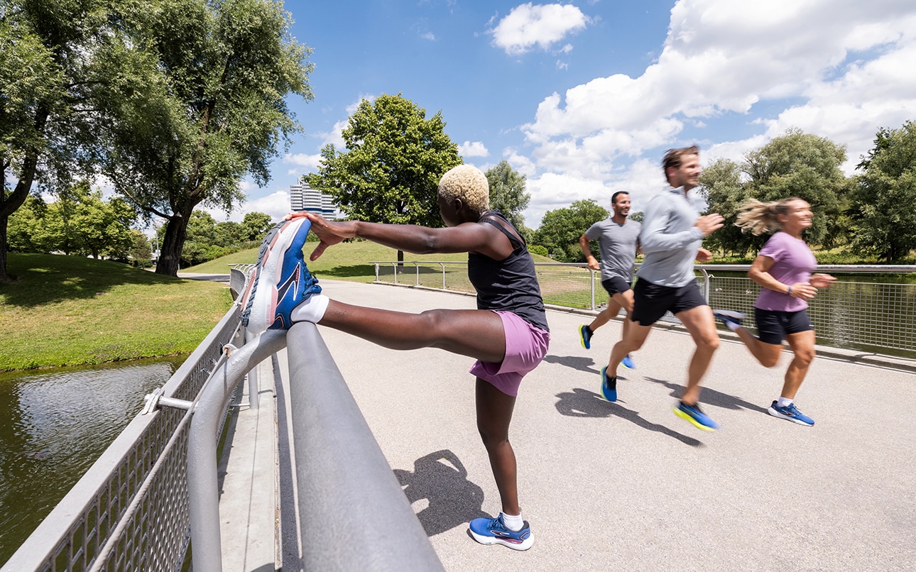 Runners performing dynamic exercises to warm up before running